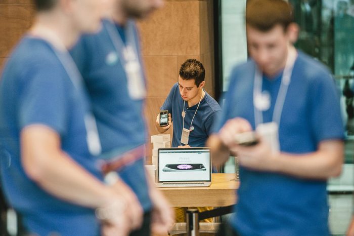 STRASBOURG, FRANCE - SEPTEMBER 19, 2014: A sales assistant scans new Apple iPhone 6 phones boxes at the Apple Store on the first day of sales of the new smart phone on September 19, 2014