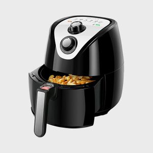Air fryer cooking fries, situated in a modern kitchen setting.