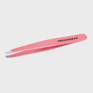 Pink metal tweezers with slanted tips lay on a white background. The word 