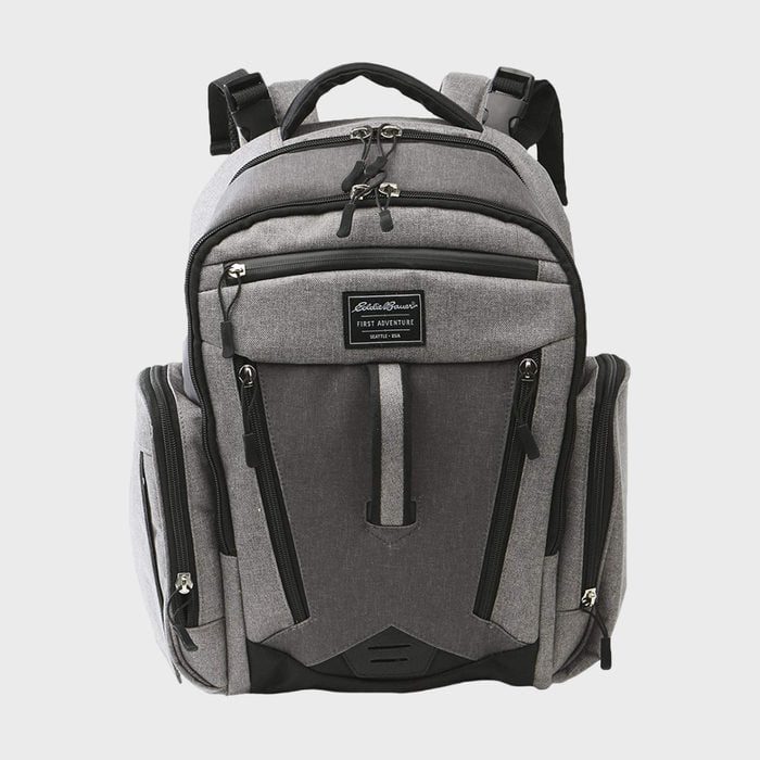 A gray backpack with multiple zippered compartments stands upright; label reads: 