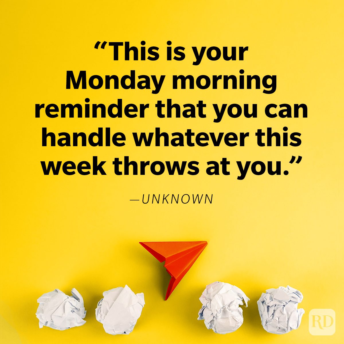 Text displays motivational quote over a yellow background. A red paper airplane rests among crumpled paper balls below.