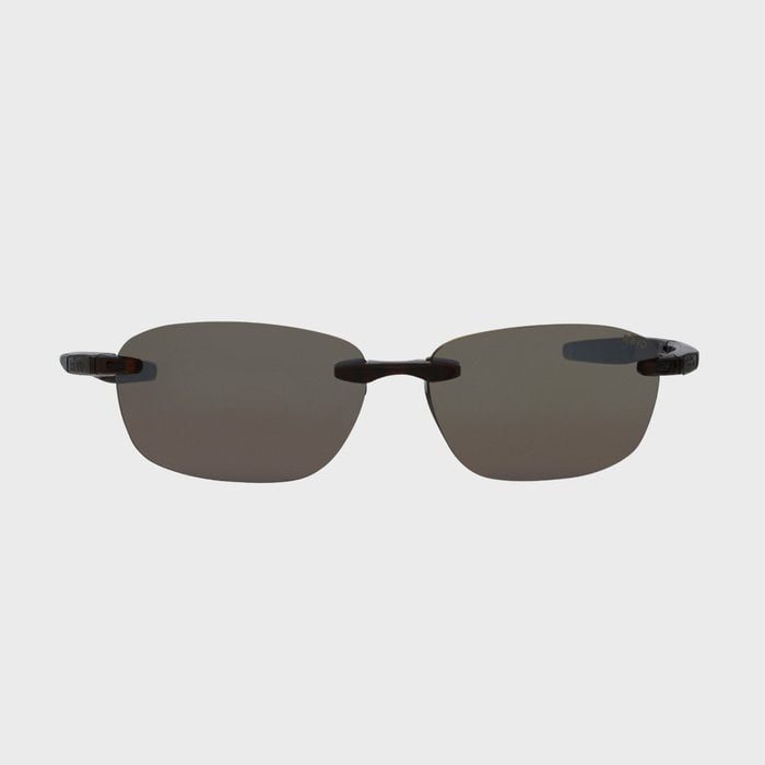 Sunglasses with black-tinted lenses rest on a white background, featuring thin frames and dark arm tips.